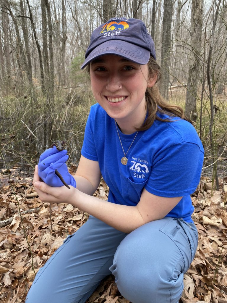 Photo of Abby Cates holding worm